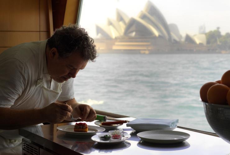 Solaré’s executive chef  Pablo Tordesillas Garcia, prepares a dish with the Sydney Opera House in the background © Jason Loucas 