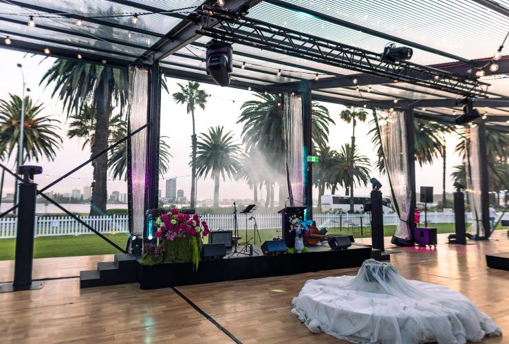 Inside The Kingsman, the podium set up for a band and the view out to the Swan River. © The Kingsman