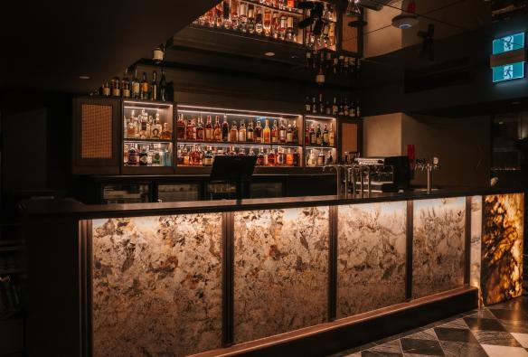 A backlit Patagonia Quartzite bar at Blackbird Bar Dining and Events. © Arianna Leggeiro