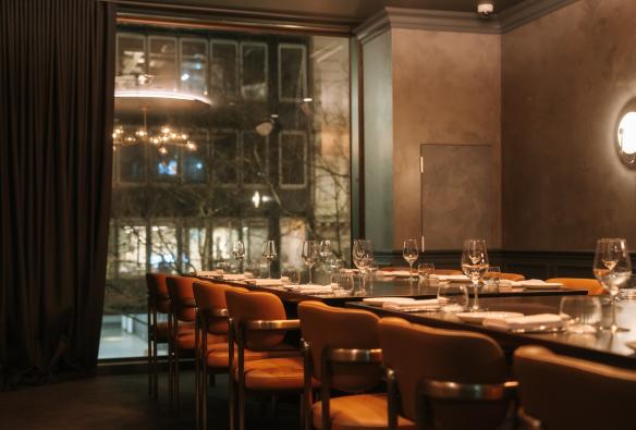 Private dining room with set table and floor to ceiling windows. © Arianna Leggeiro