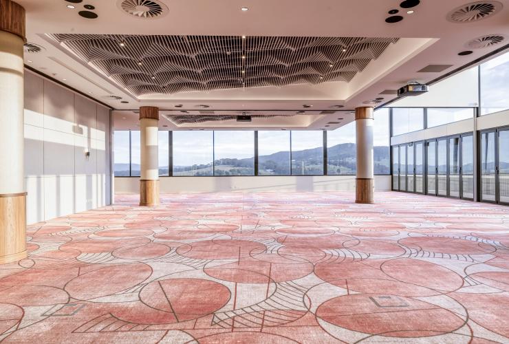 Panorama Hall with floor to ceiling windows and coral hued tile floors. © Mount View Estate