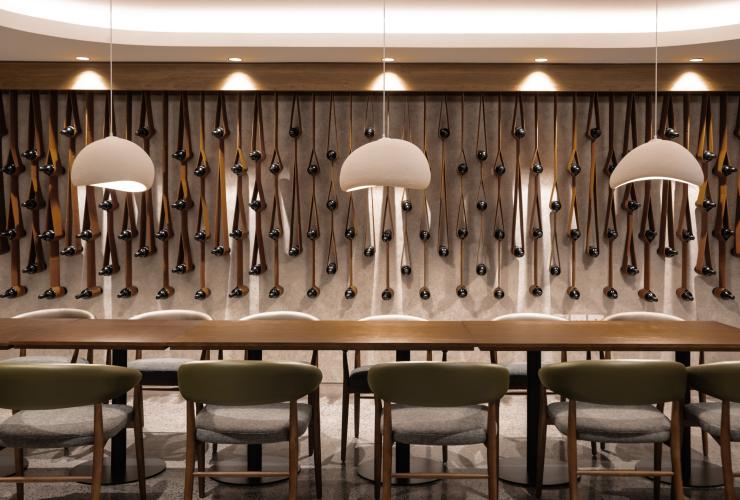 The Restaurant at Mount View Estate with contemporary lighting and wine bottle wall design. © Mount View Estate