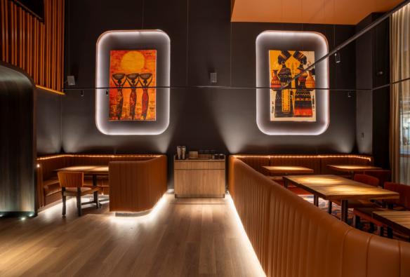 Leather booths and large colourful art set the scene in a moodily-lit restaurant © 7 Cutz 