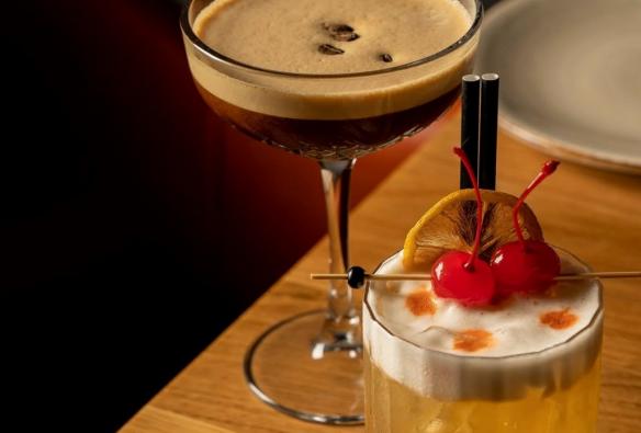 Espresso martini and amaretto sour sit freshly made on a restaurant table © 7 Cutz  