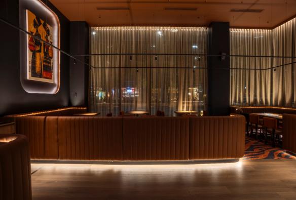 Large leather booths, moody lighting and draped curtains set the scene in a restaurant © 7 Cutz