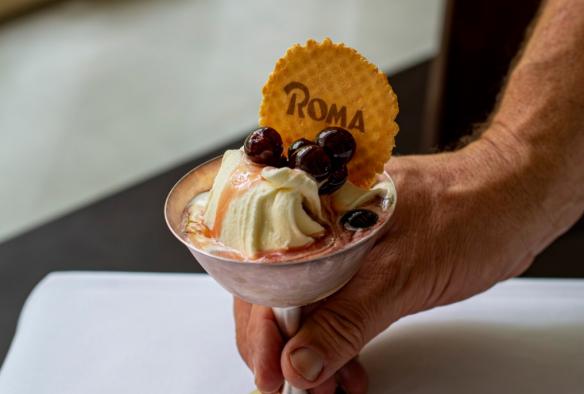 A dessert of gelati topped with berries and a wafer biscuit is served © Roma Ristorante