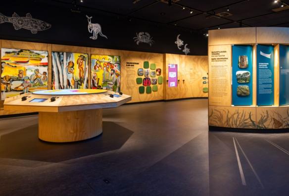 Artwork and cultural objects are displayed inside a cultural centre. © Larrakia Cultural Centre