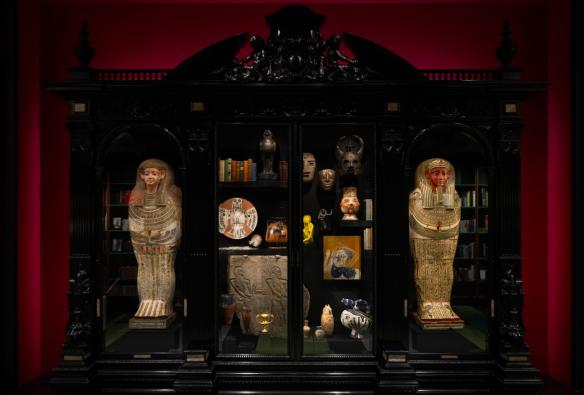  Ancient artifacts from Egypt and around the world sit in an ornate wood and glass cabinet. © MONA/Jesse Hunniford