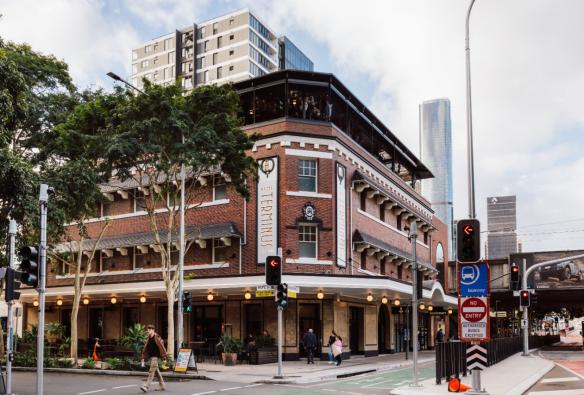 The heritage facade of a renovated pub sits on a busy city street. © Hotel Terminus