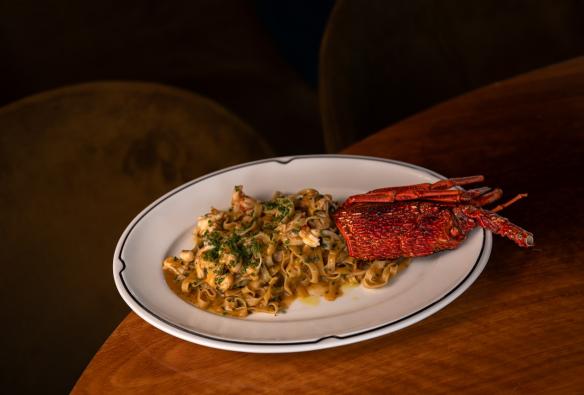 A close up of a restaurant meal of handmade pasta and a lobster. © The Oriana / Brooke Maxwell