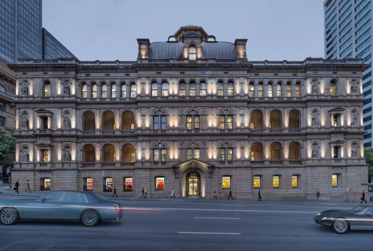 Five story sandstone building, with arch windows lit up at night. This is the external fascade of the Lands by Capella, Sydney, New South Wales © Evolving Picture / Capella